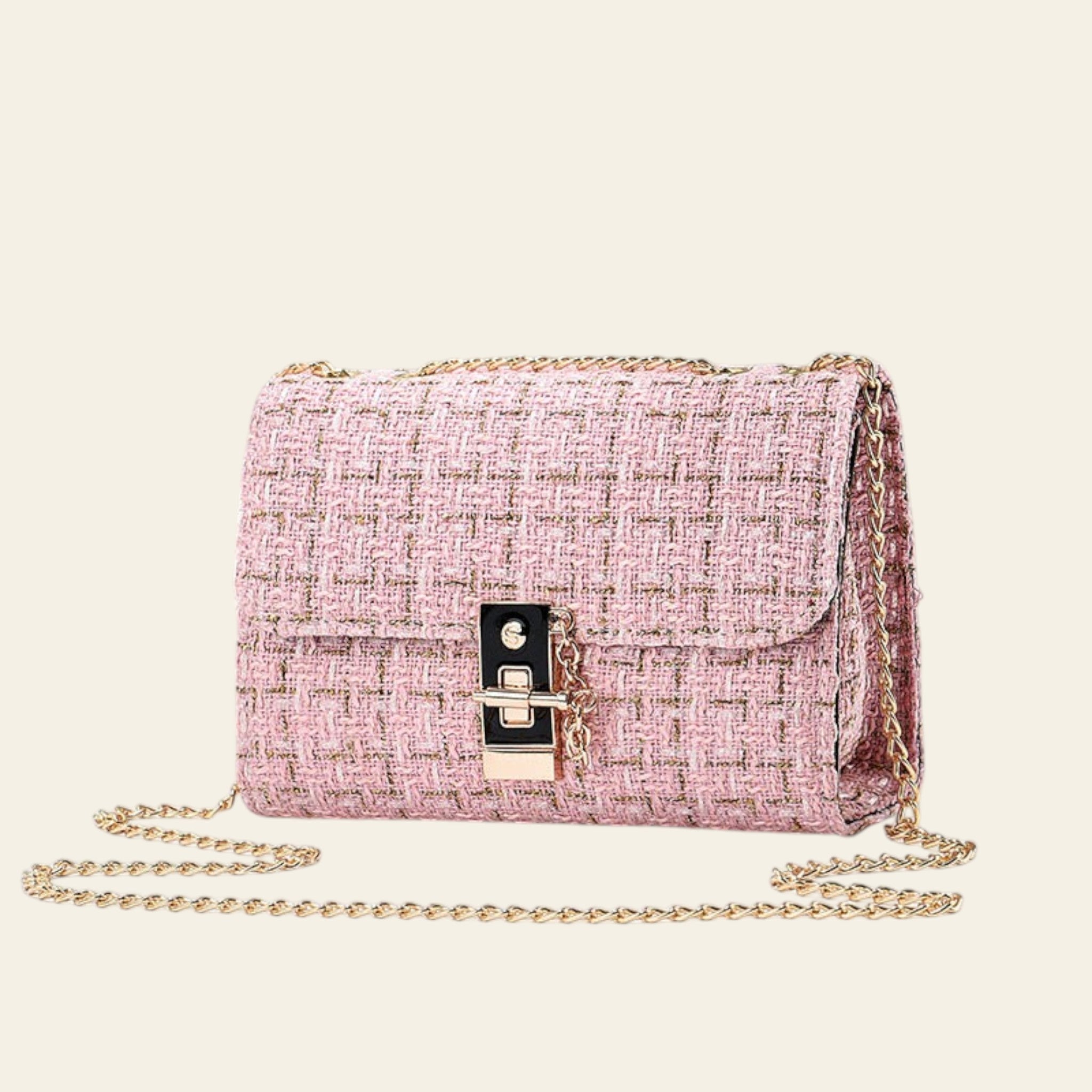 Pink textured handbag with gold chain on a light gray background