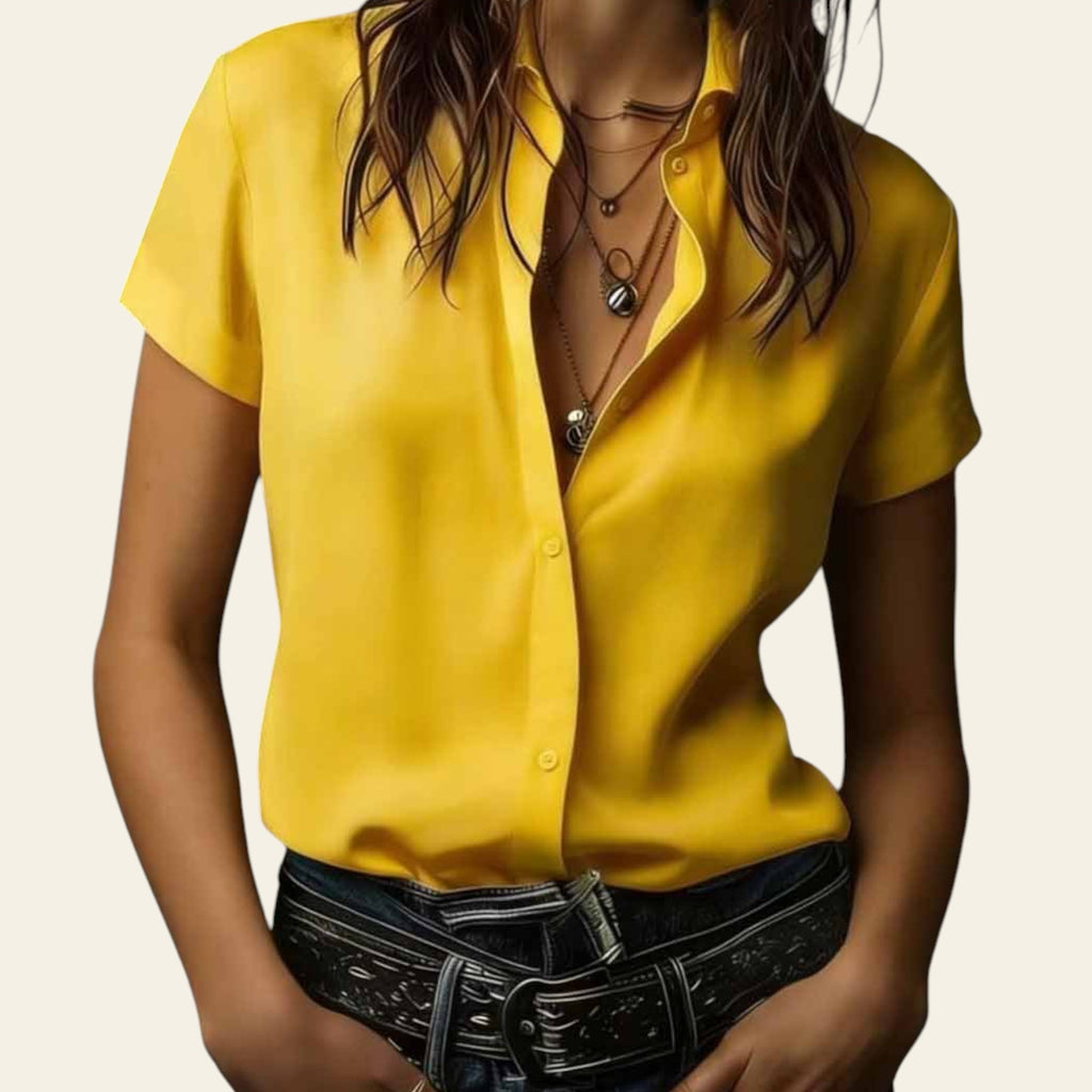 Person wearing a yellow shirt with a dark background