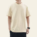 Man wearing an apricot loose fit solid color t-shirt