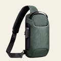 Green shoulder bag with a black strap on a white background