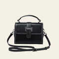 Black handbag with a strap on a white background