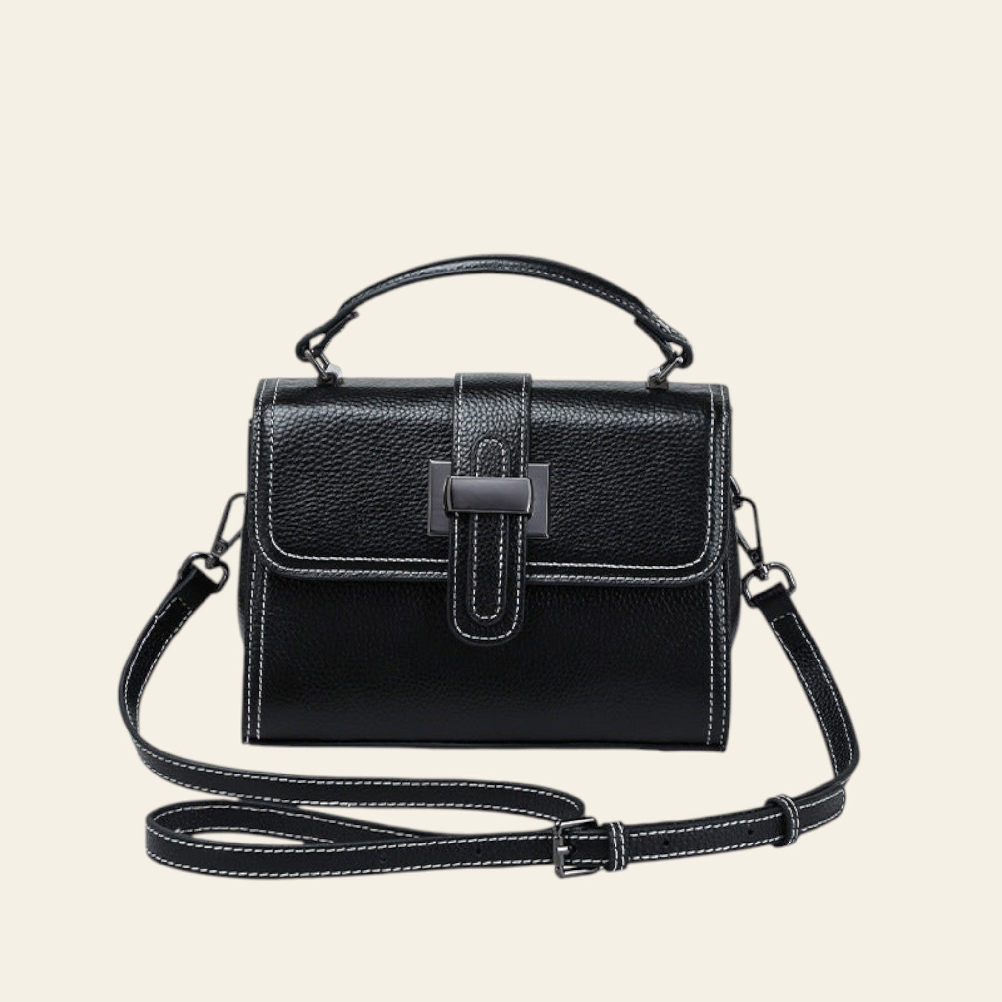 Black handbag with a strap on a white background