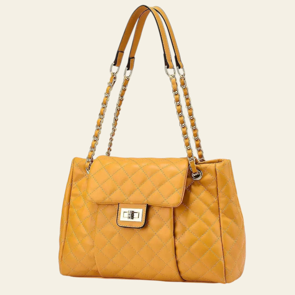 Yellow quilted handbag with chain detail on a beige background