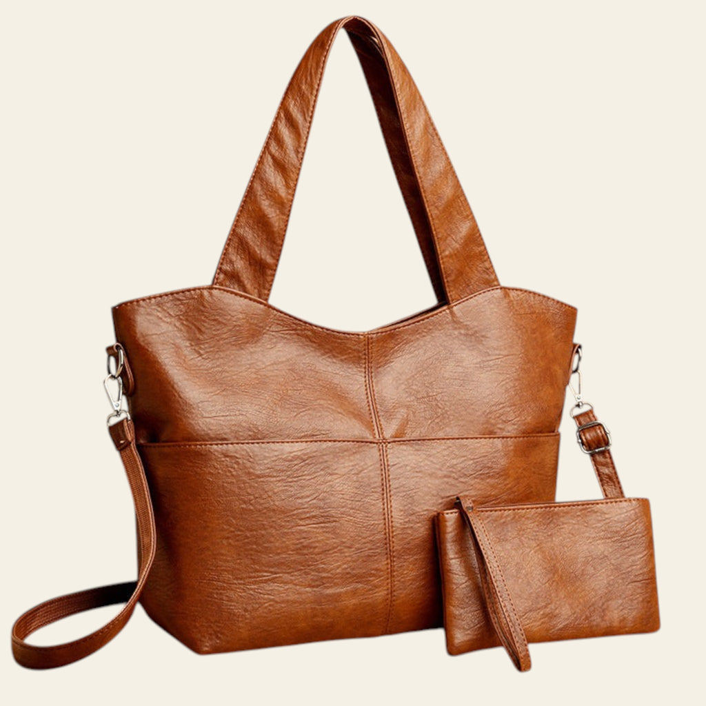 Brown leather handbag with matching pouch on a beige background