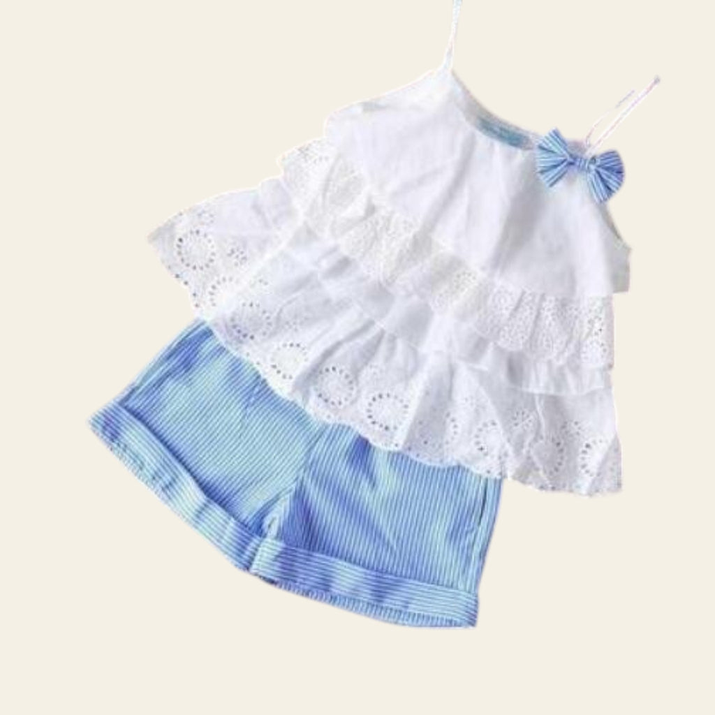 White lace top and blue striped shorts set on a wooden surface