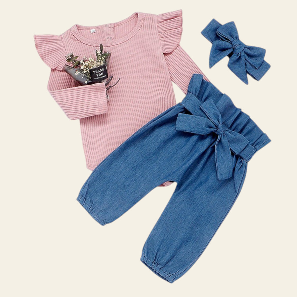 Pink top and blue pants with a bow, accompanied by a blue hair bow on a white background.