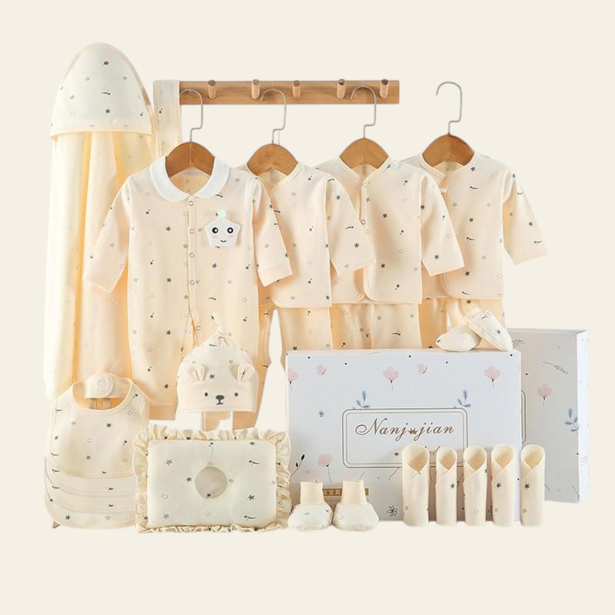 Baby clothing set with shirts, pants, and accessories on a white background