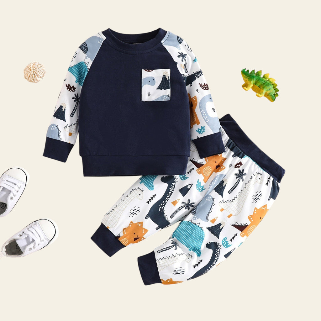 Children's outfit with navy sweatshirt and patterned pants on a beige background