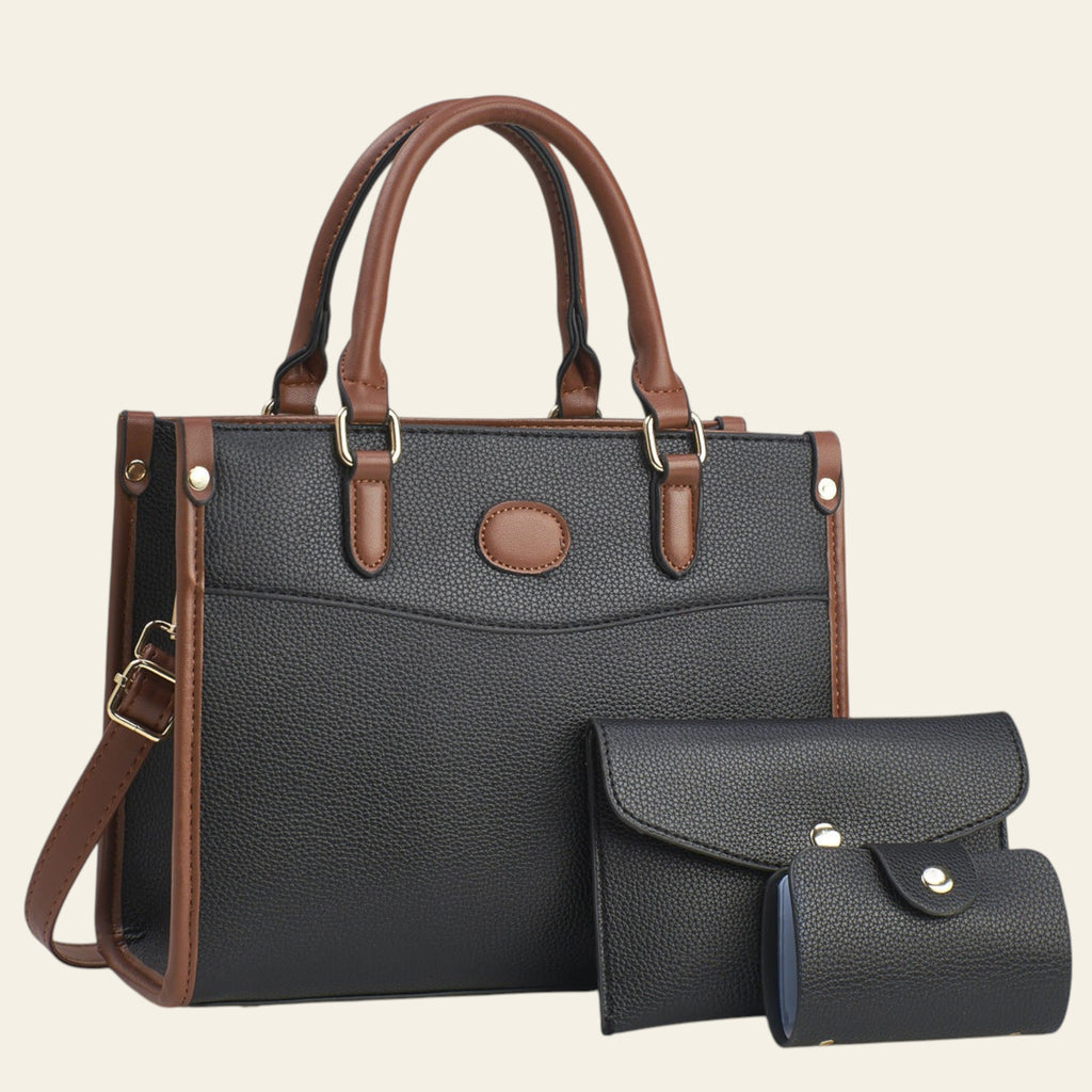 Black leather handbag with brown handles and trim on a light background