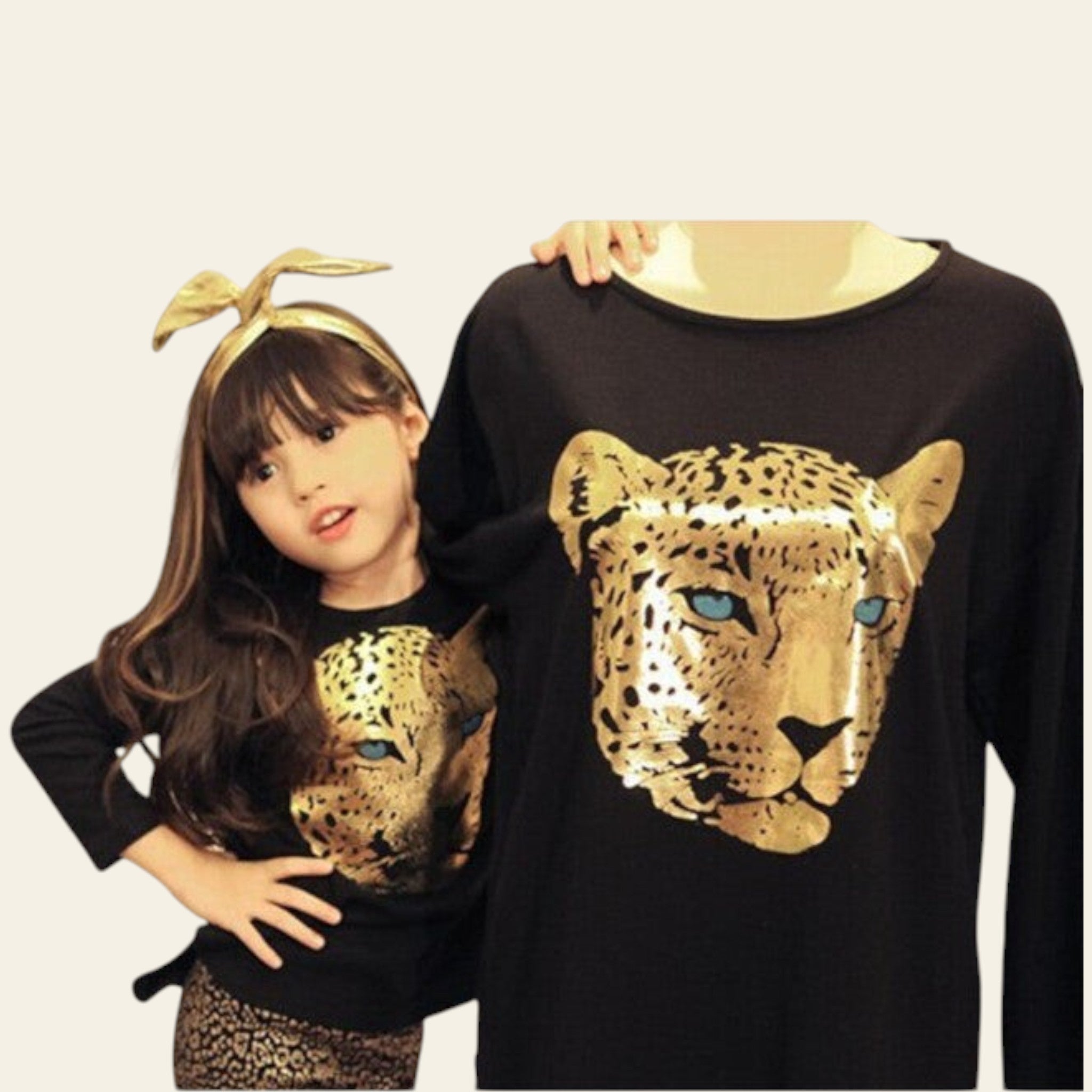 Two people wearing black sweatshirts with gold leopard designs.