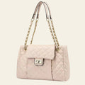 Quilted beige handbag with chain strap on a beige background