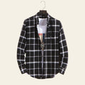 Black plaid men's long sleeve casual shirt hanging on wall