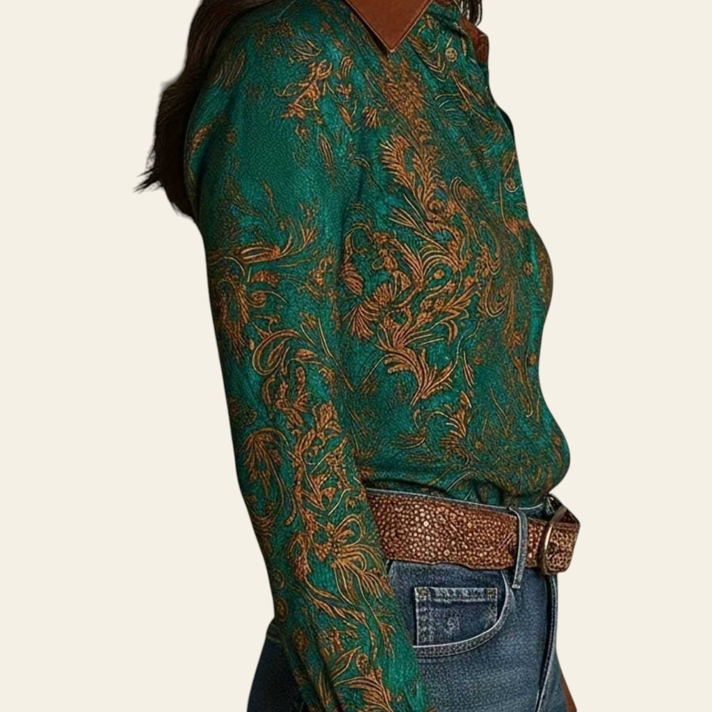 Person wearing a green patterned shirt with a brown belt against a neutral background