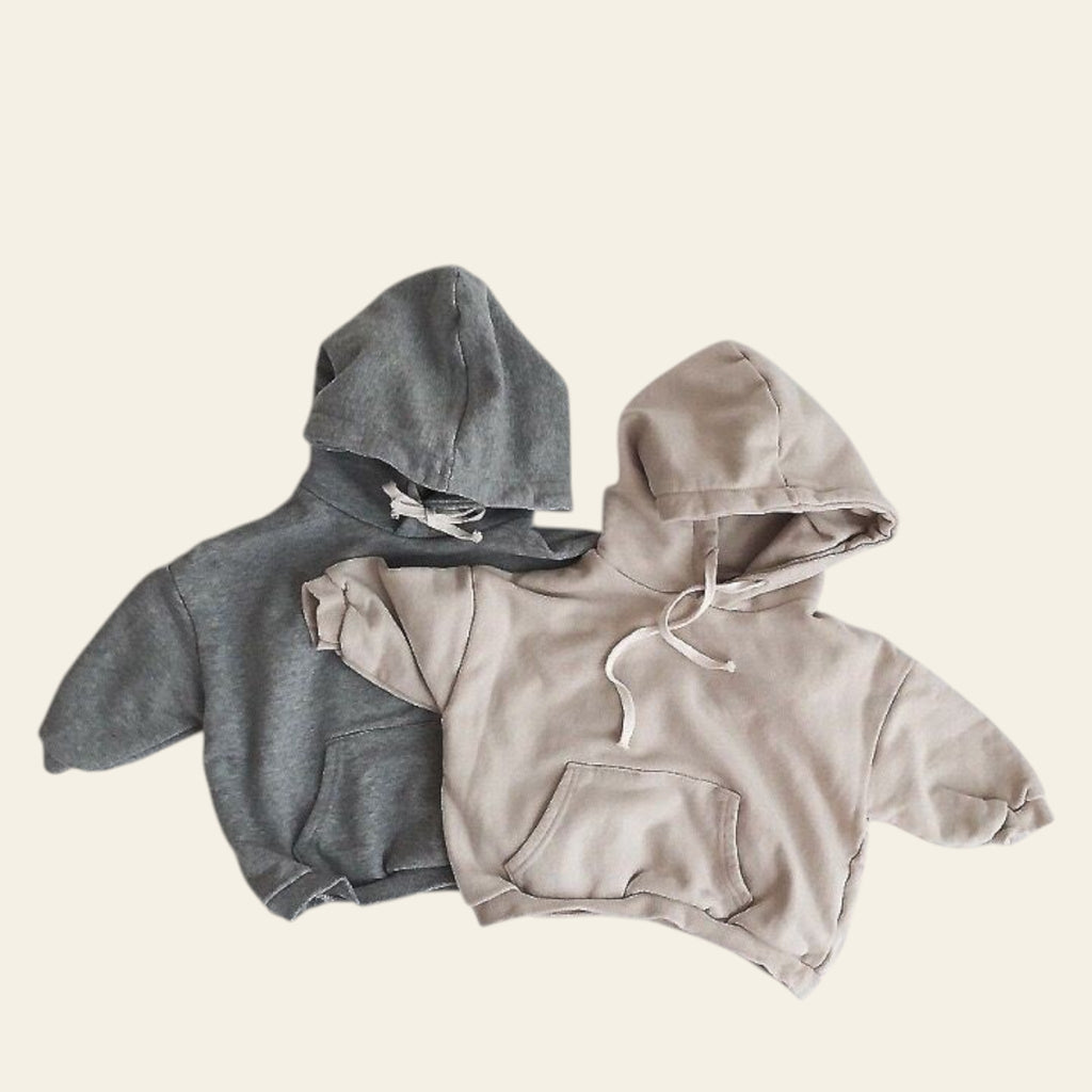 Two hoodies, one gray and one beige, on a light gray background