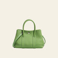 Green handbag on a white background