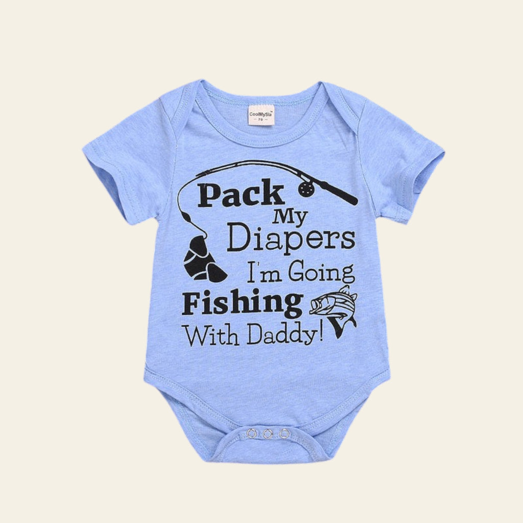 Light blue baby onesie with text on a wooden surface