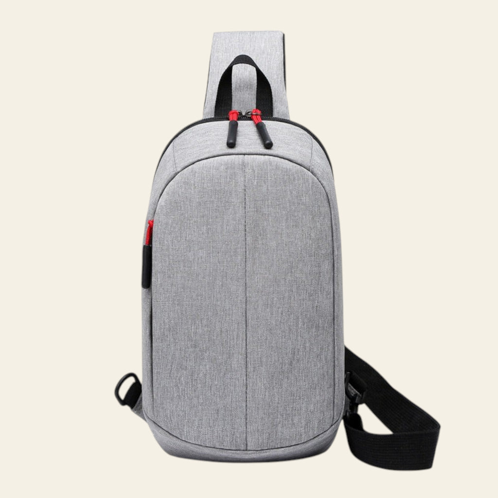 Gray shoulder bag with black straps on a white background