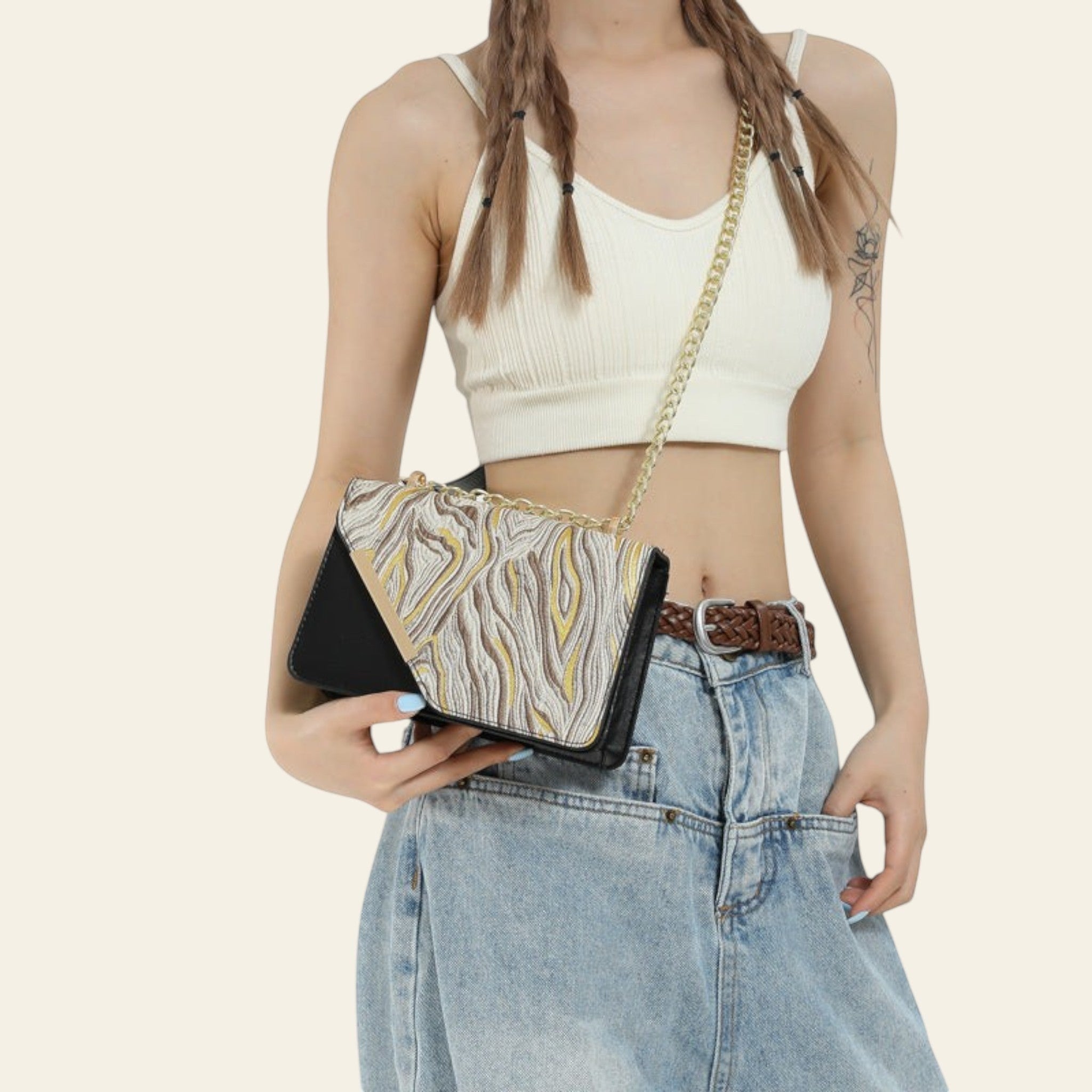 Person holding a patterned handbag with a plain background