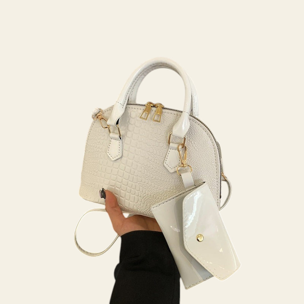 White textured leather satchel bag with top handle and crossbody strap