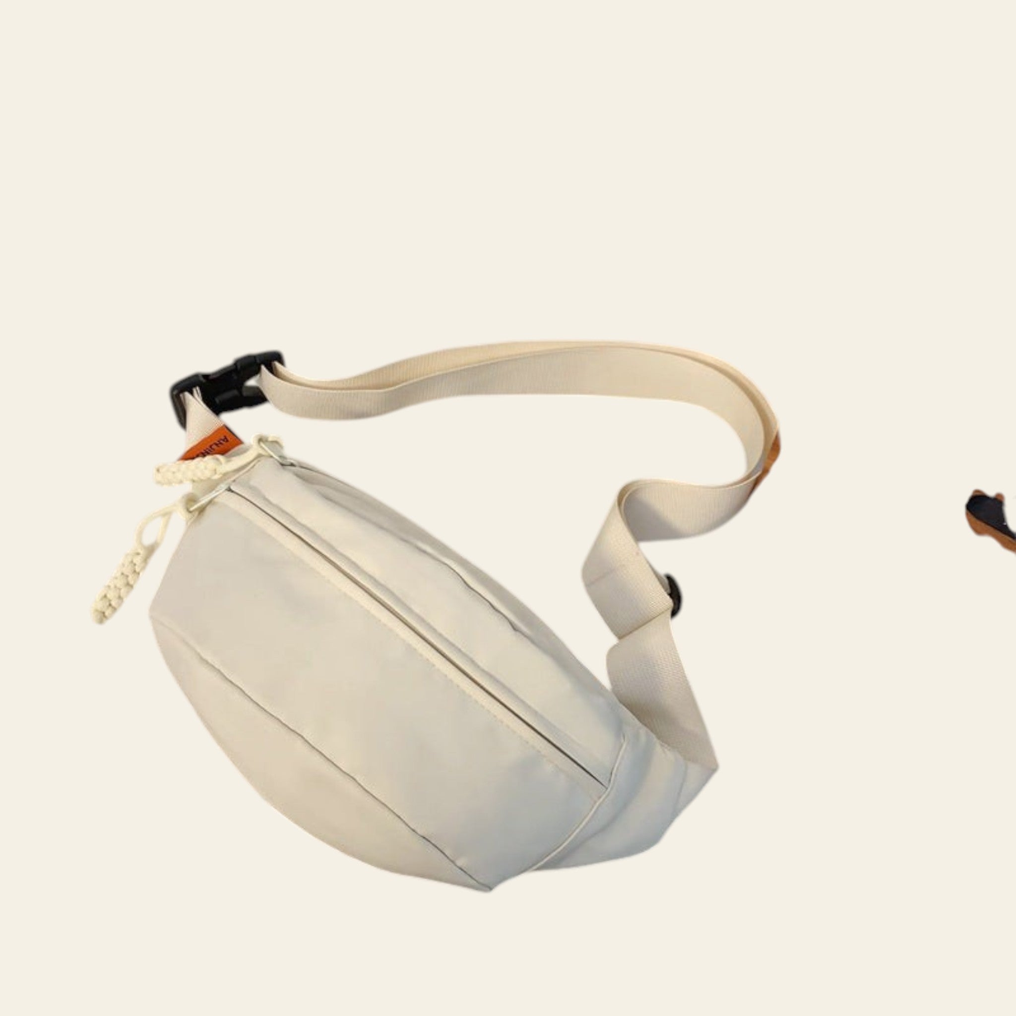 White bag on a glass table with a book and wooden clock in the background