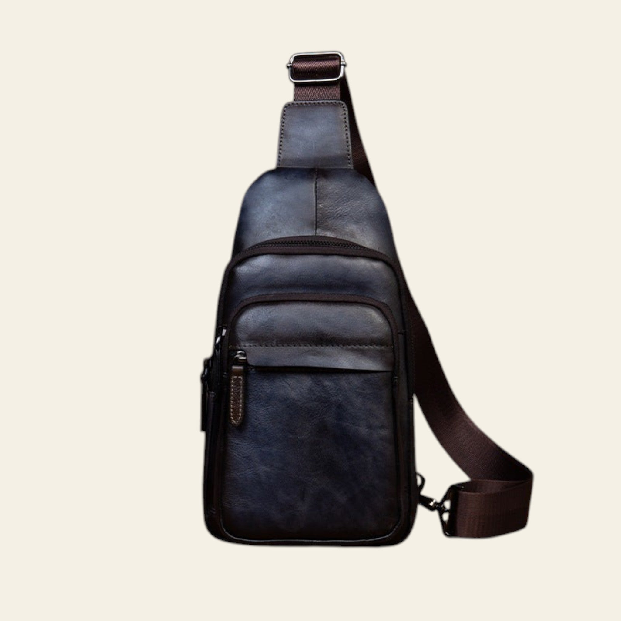 Blue leather sling bag on a wooden surface with a rustic background