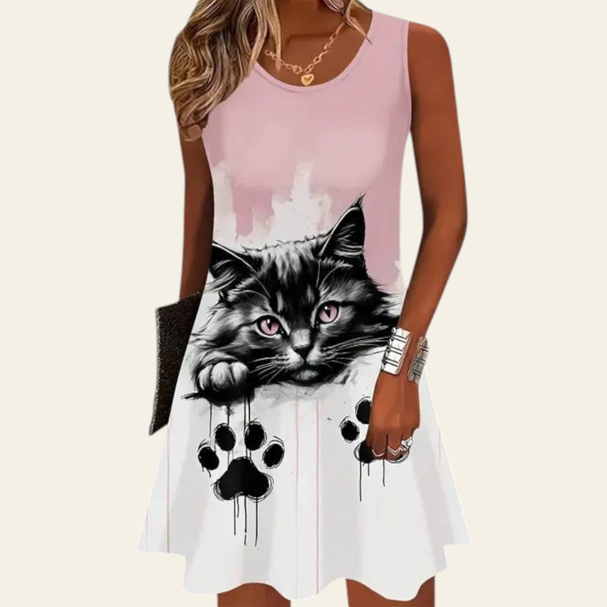 woman wearing a sleeveless white dress with a black cat face print