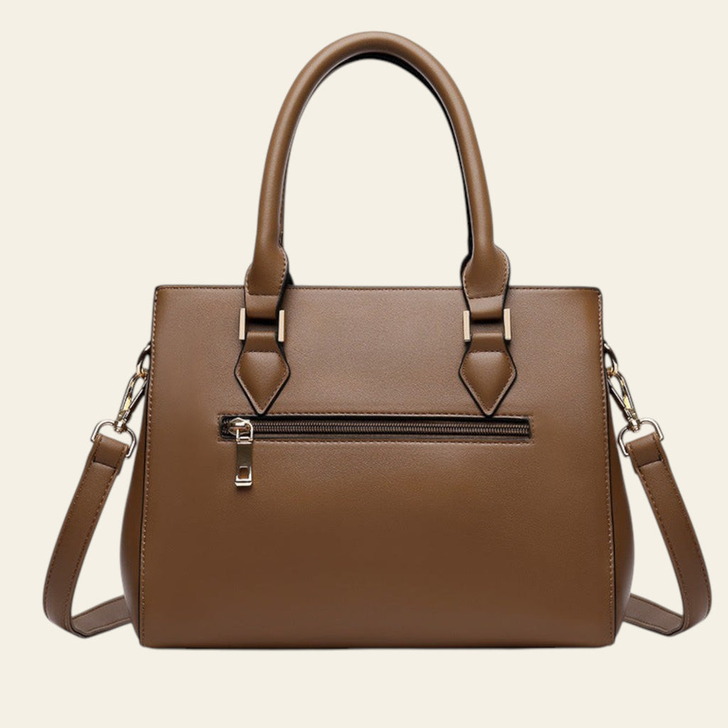 Brown handbag with a shoulder strap on a white background