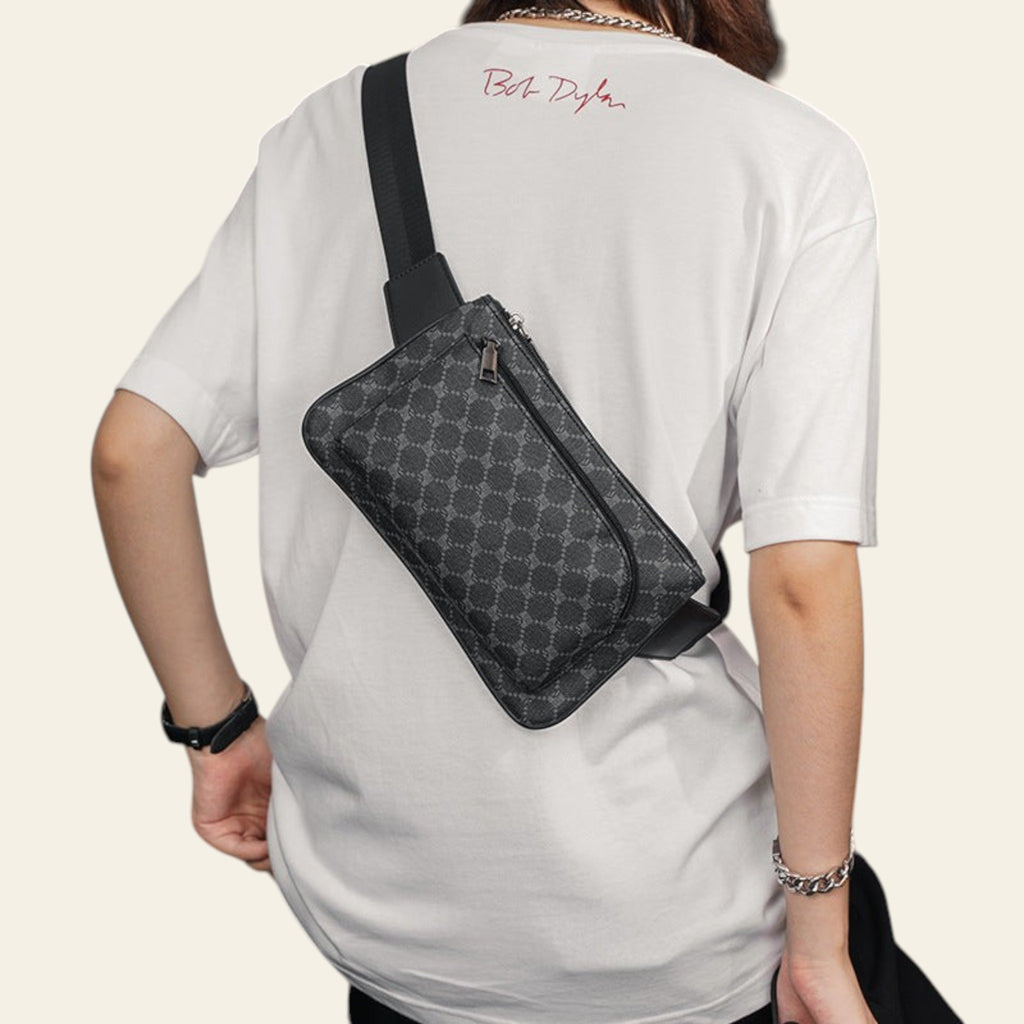 Person wearing a white t-shirt with 'Bob Dylan' text and a black patterned crossbody bag.
