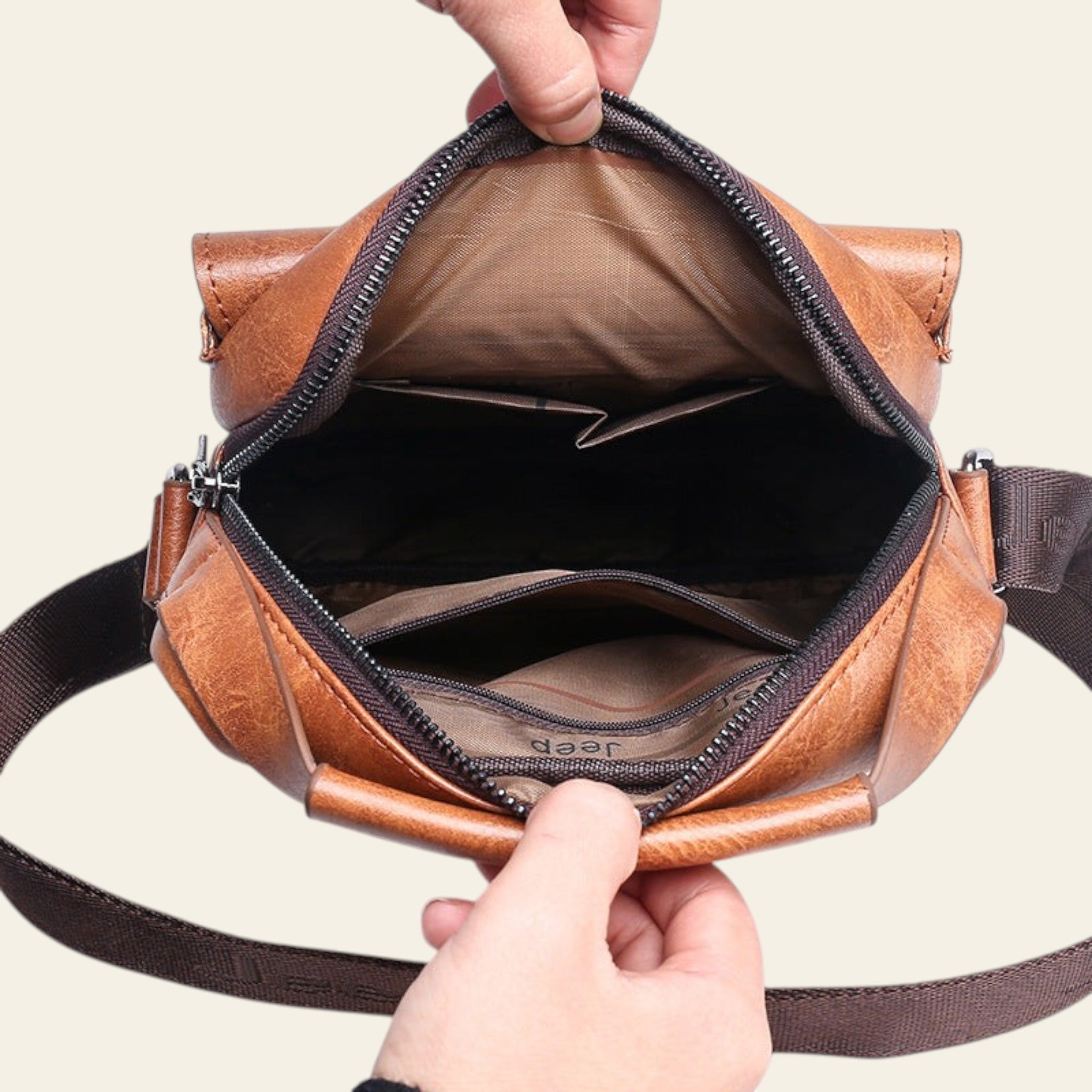 Brown leather bag with a zipper being opened by hands on a white background