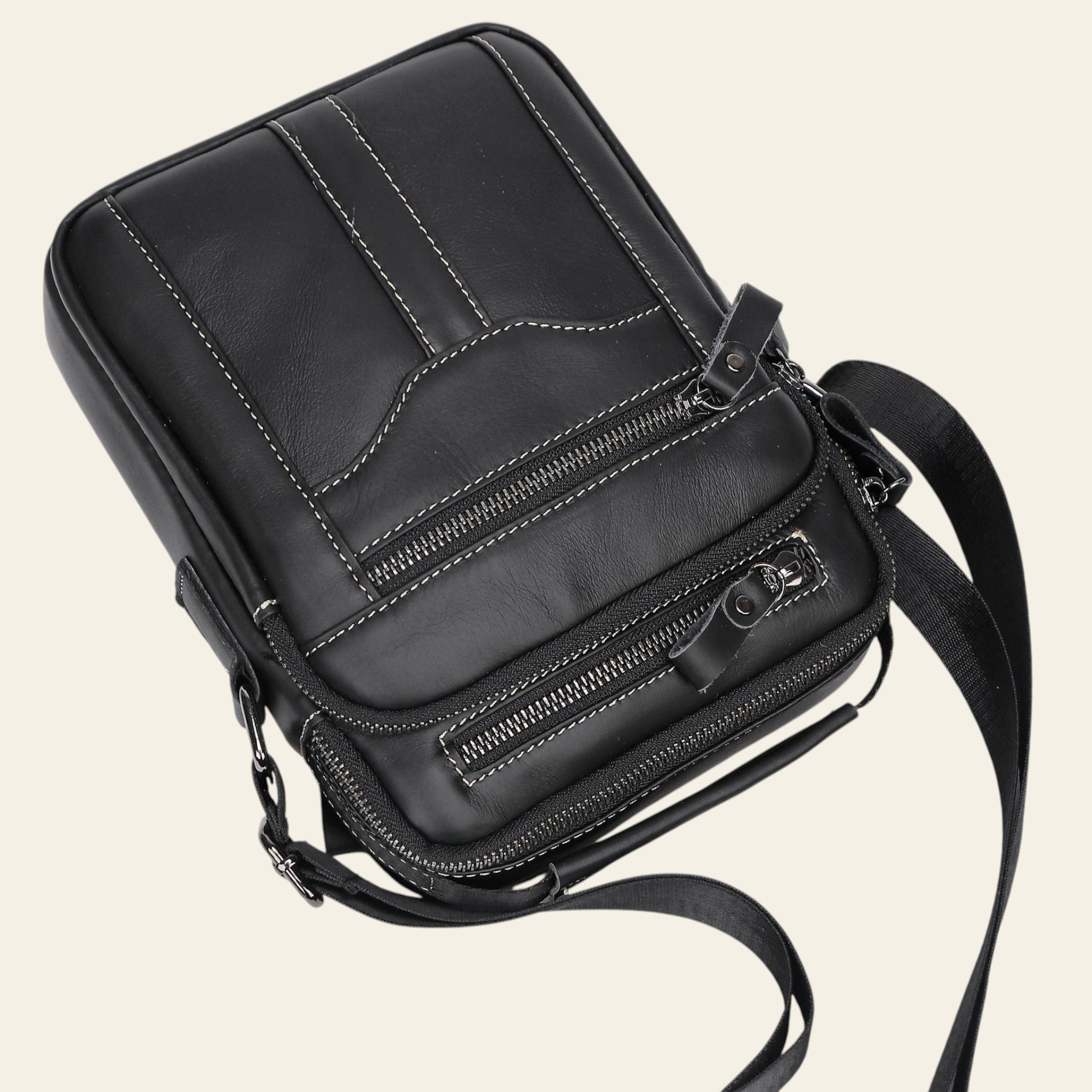 Black leather crossbody bag on a light gray background