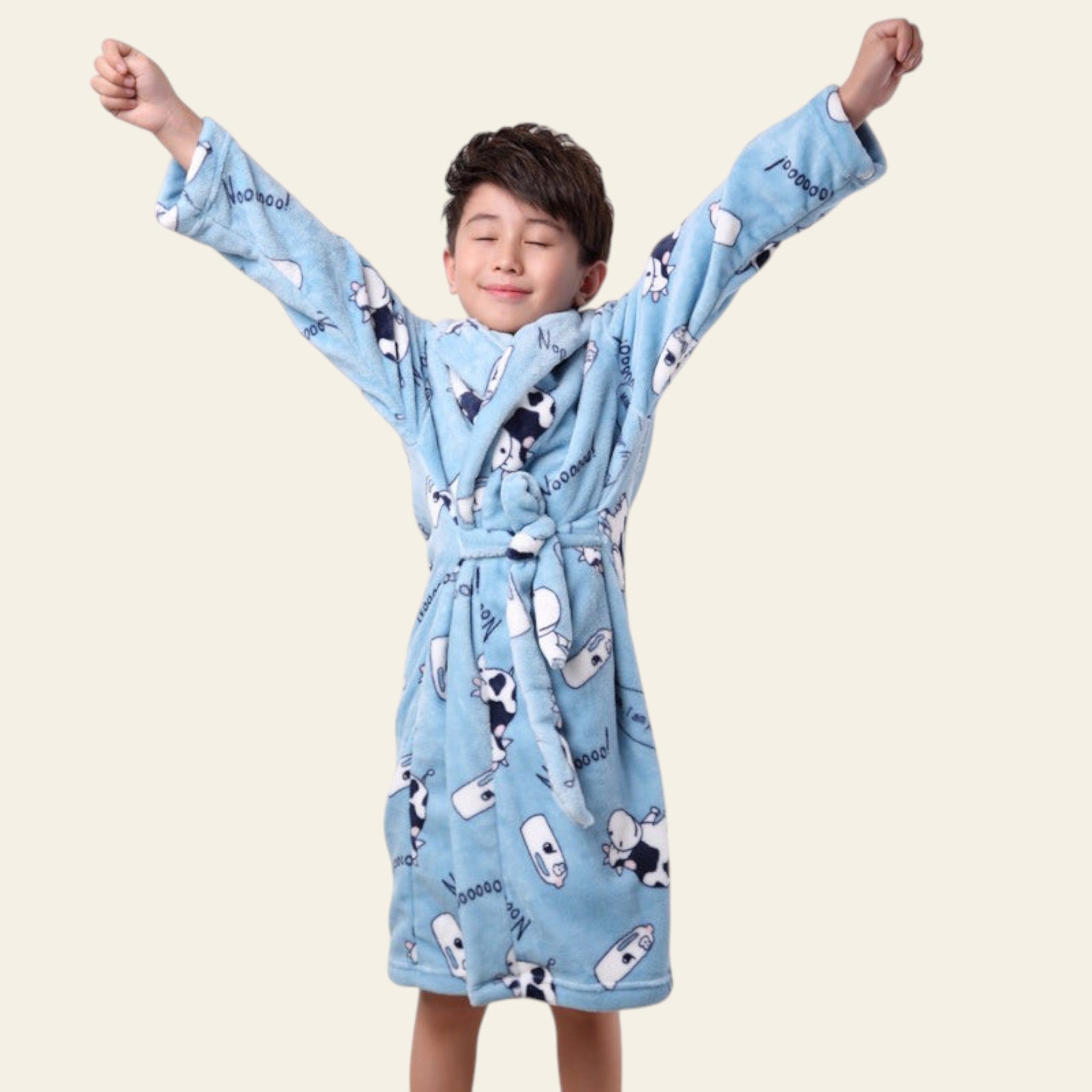 Child wearing a blue robe with cartoon designs against a white background