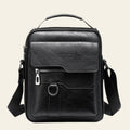 Black leather crossbody bag on a white background