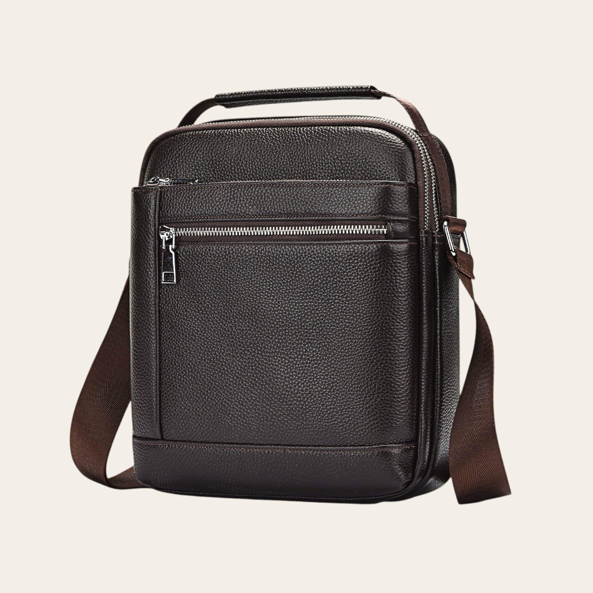 Brown leather crossbody bag on a light blue background