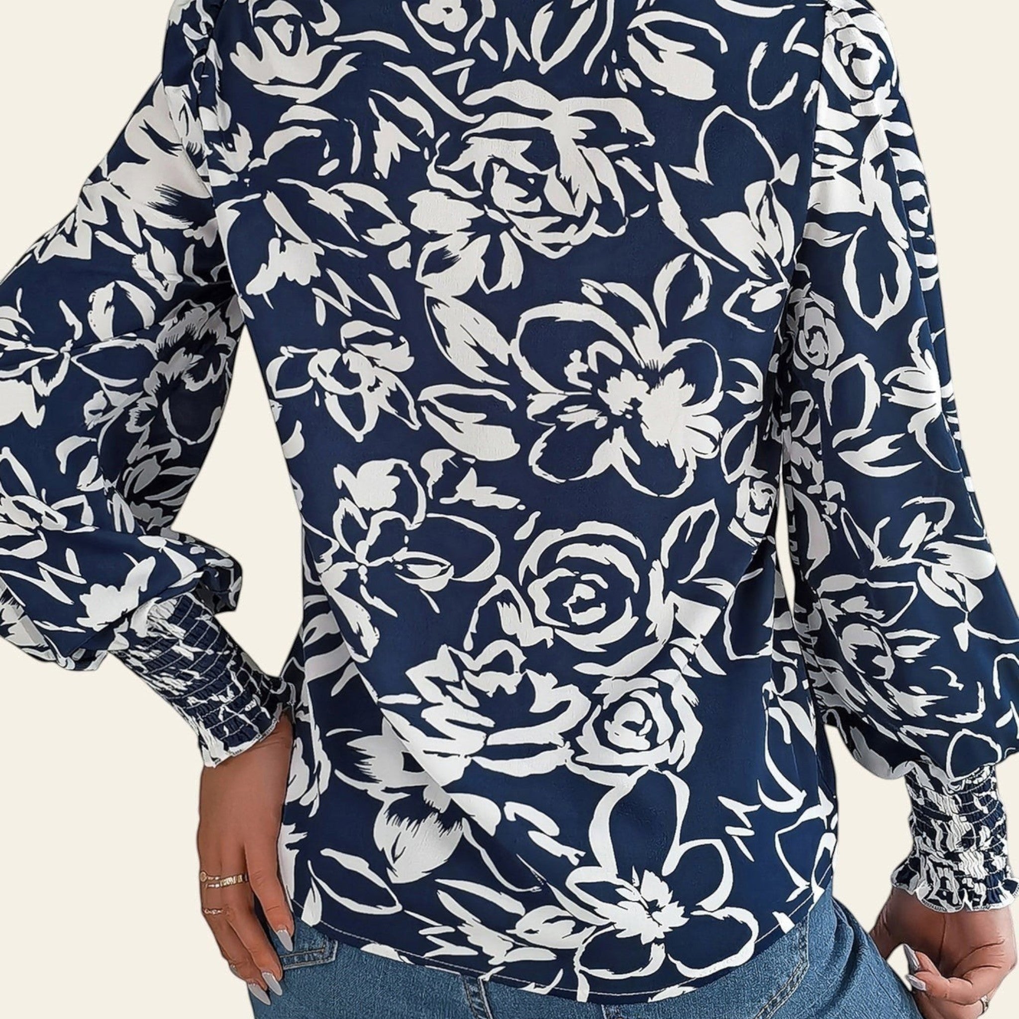 Navy blue floral patterned shirt worn by a person on a white background