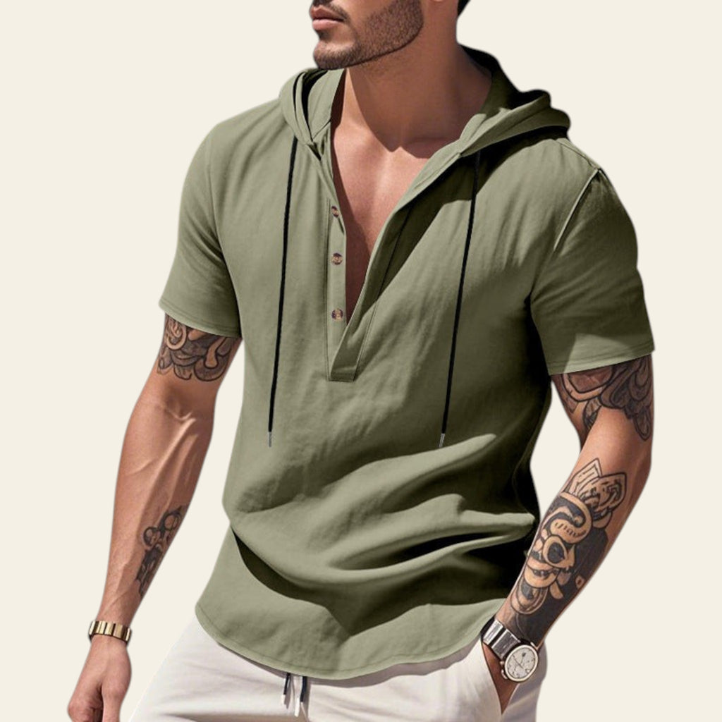 Man wearing an army green breathable linen hooded short sleeve henley shirt at the beach