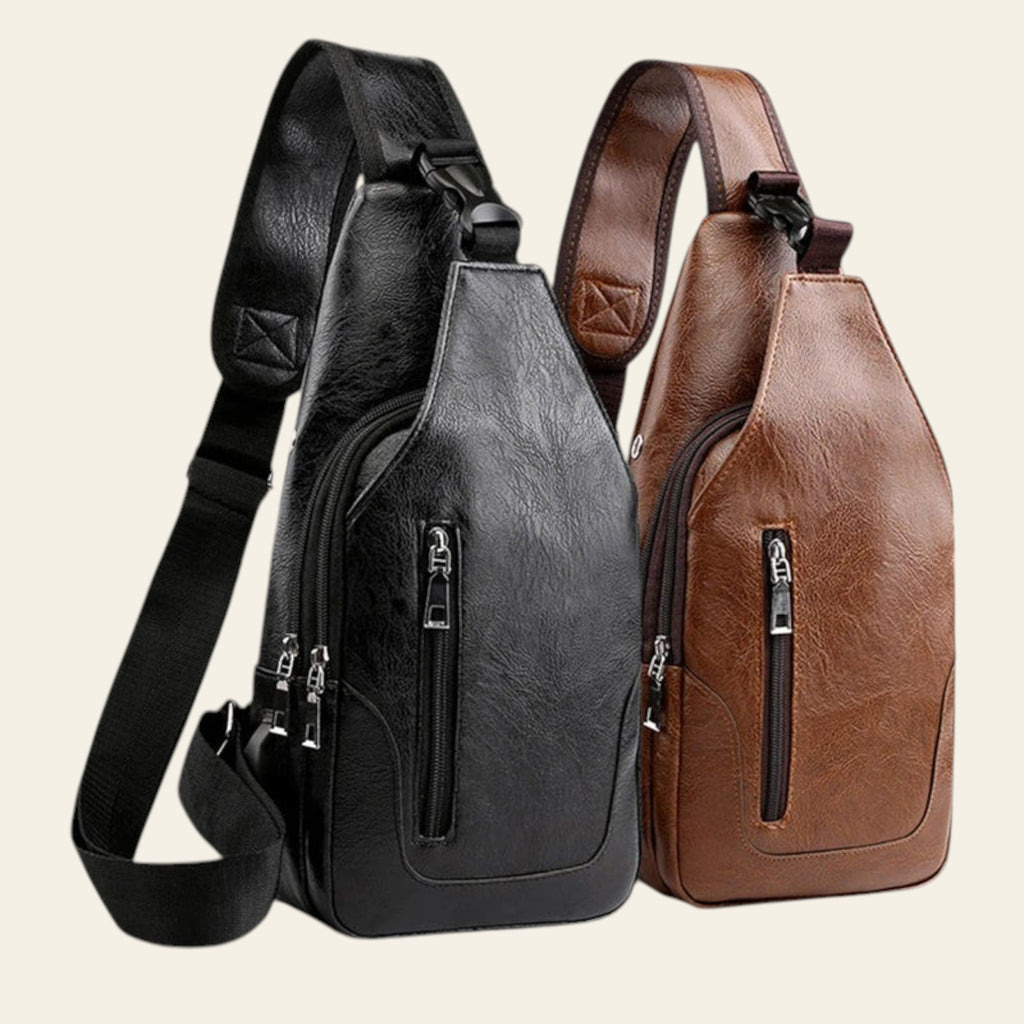 Black and brown leather sling bags on a wooden surface with a scenic background.