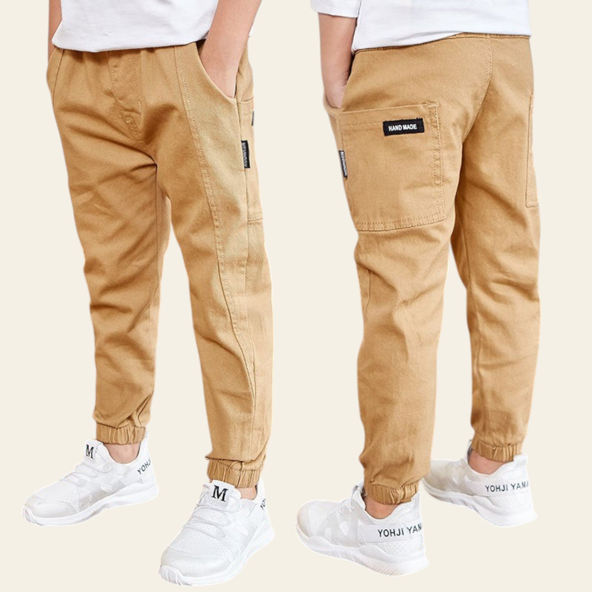 Two pairs of tan jogger pants worn by people standing on a wooden floor with Starbucks logos in the background.