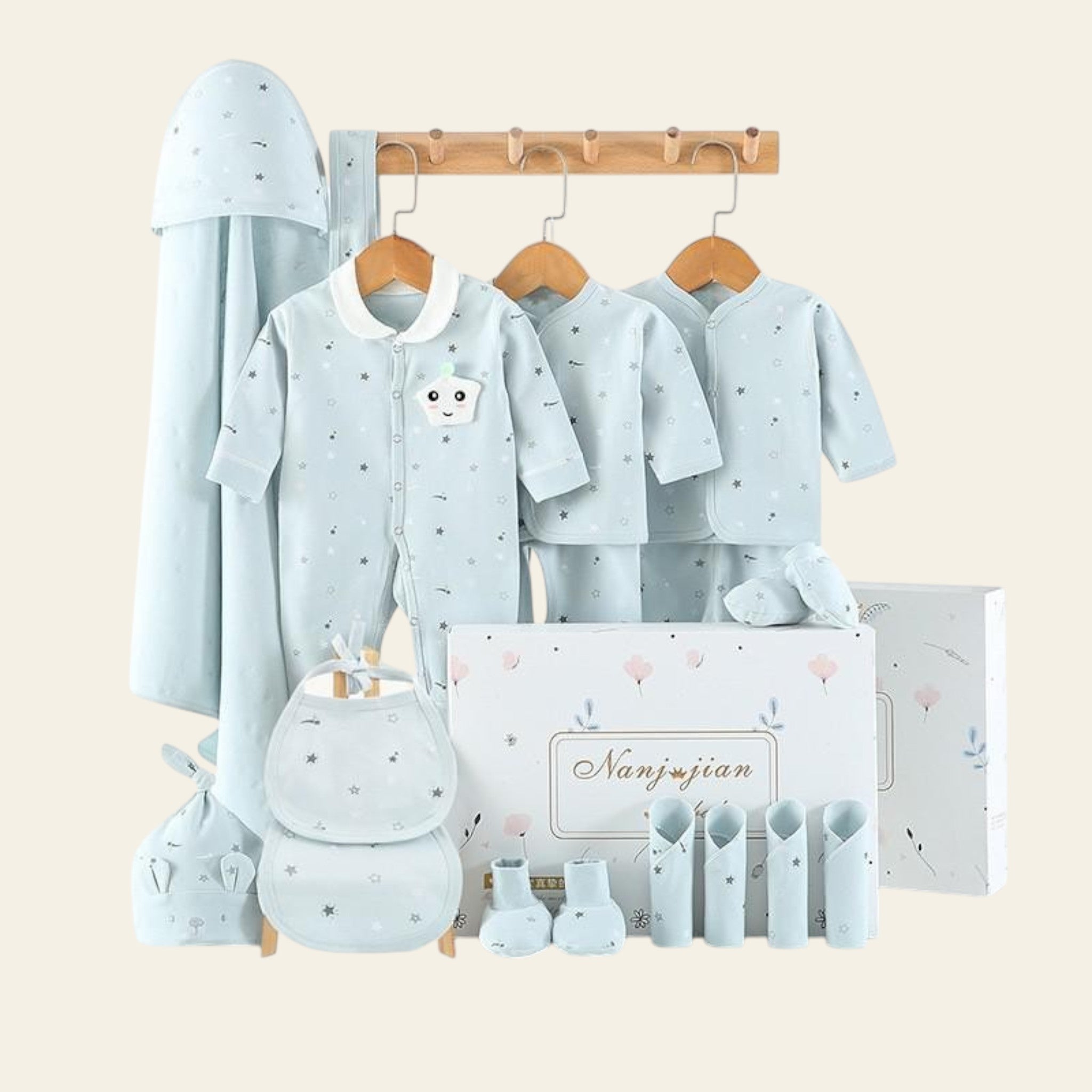 Baby clothing set with shirts, pants, and accessories on a white background