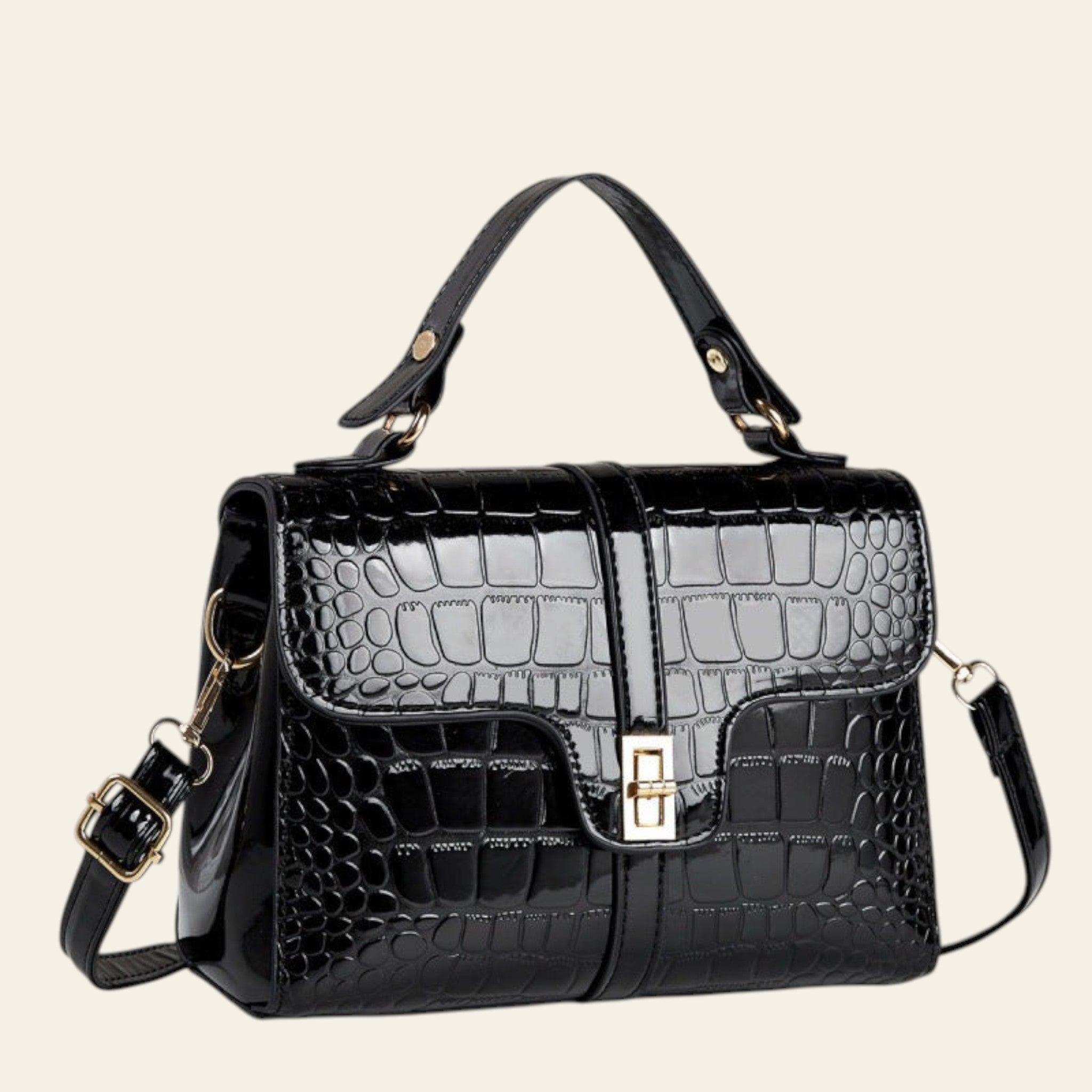 Black crocodile-patterned handbag on a light surface with a neutral background