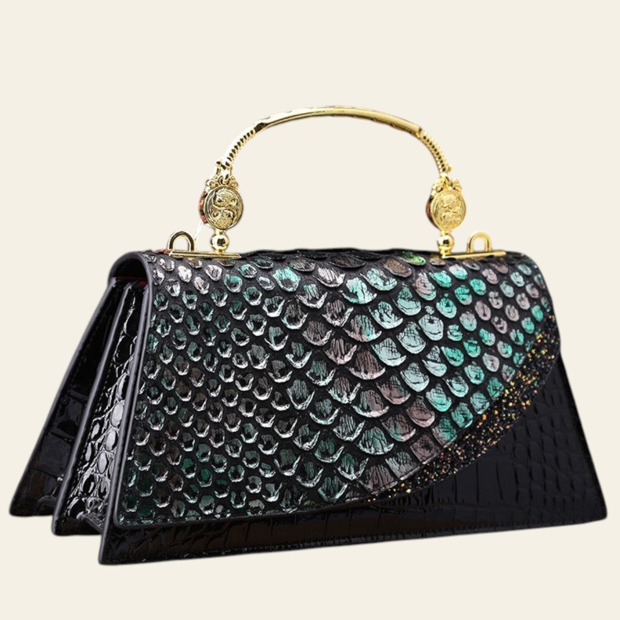 Black handbag with gold accents on a wooden surface with pink flowers in the background