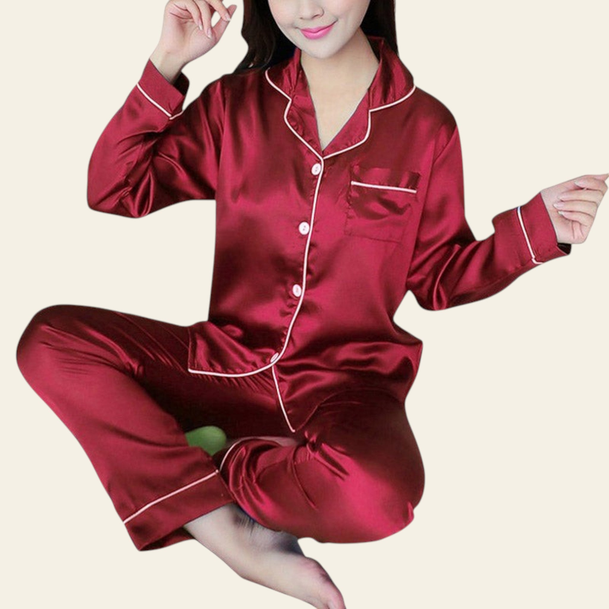 Red satin pajama set worn by a person on a white background