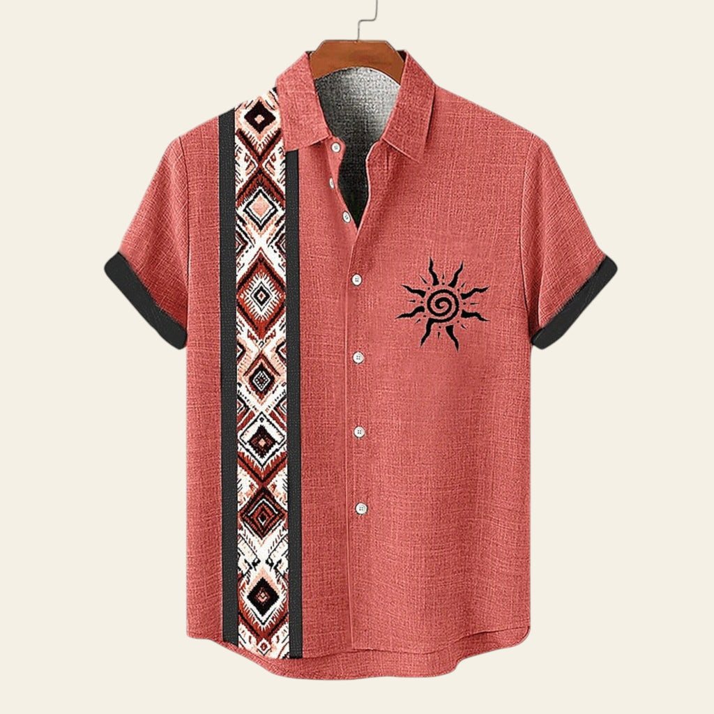 Red button-up shirt with tribal pattern and sun design on a hanger against a white background.