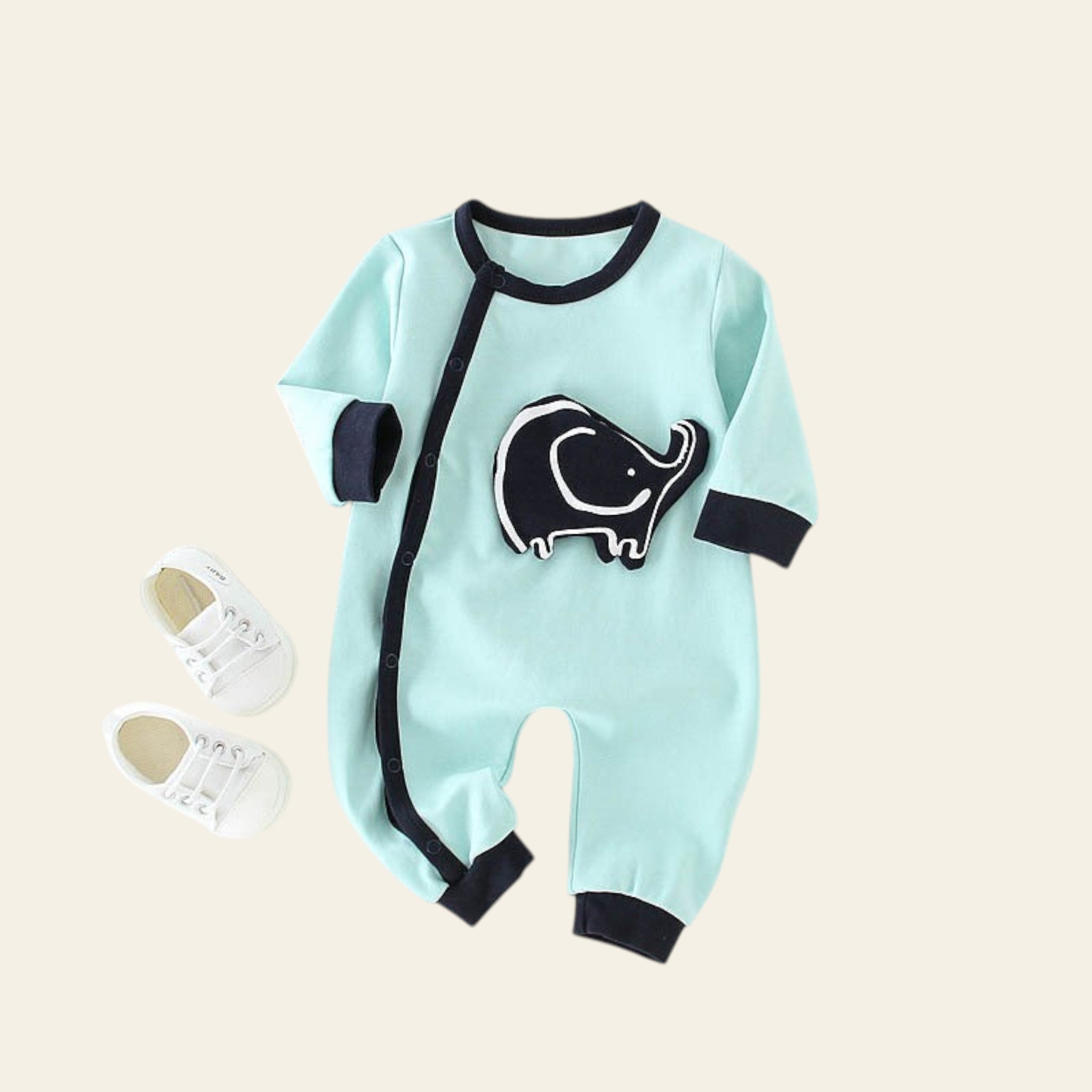 Light blue baby romper with black elephant design on a white surface