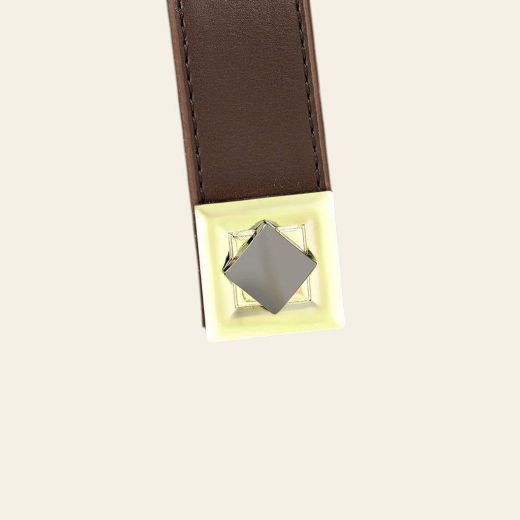 Close-up of a green leather bag with a brown strap and gold clasp.