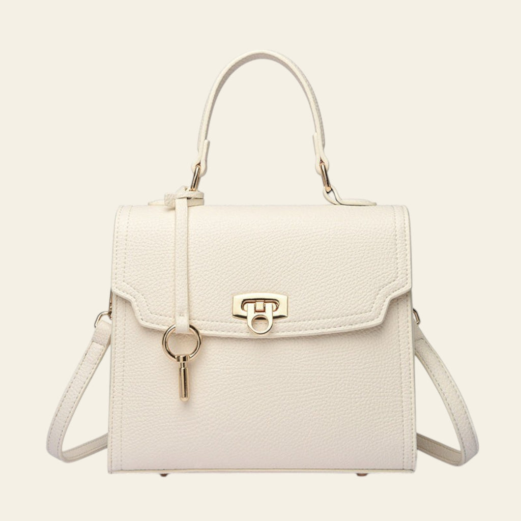 White handbag with gold accents on a white background