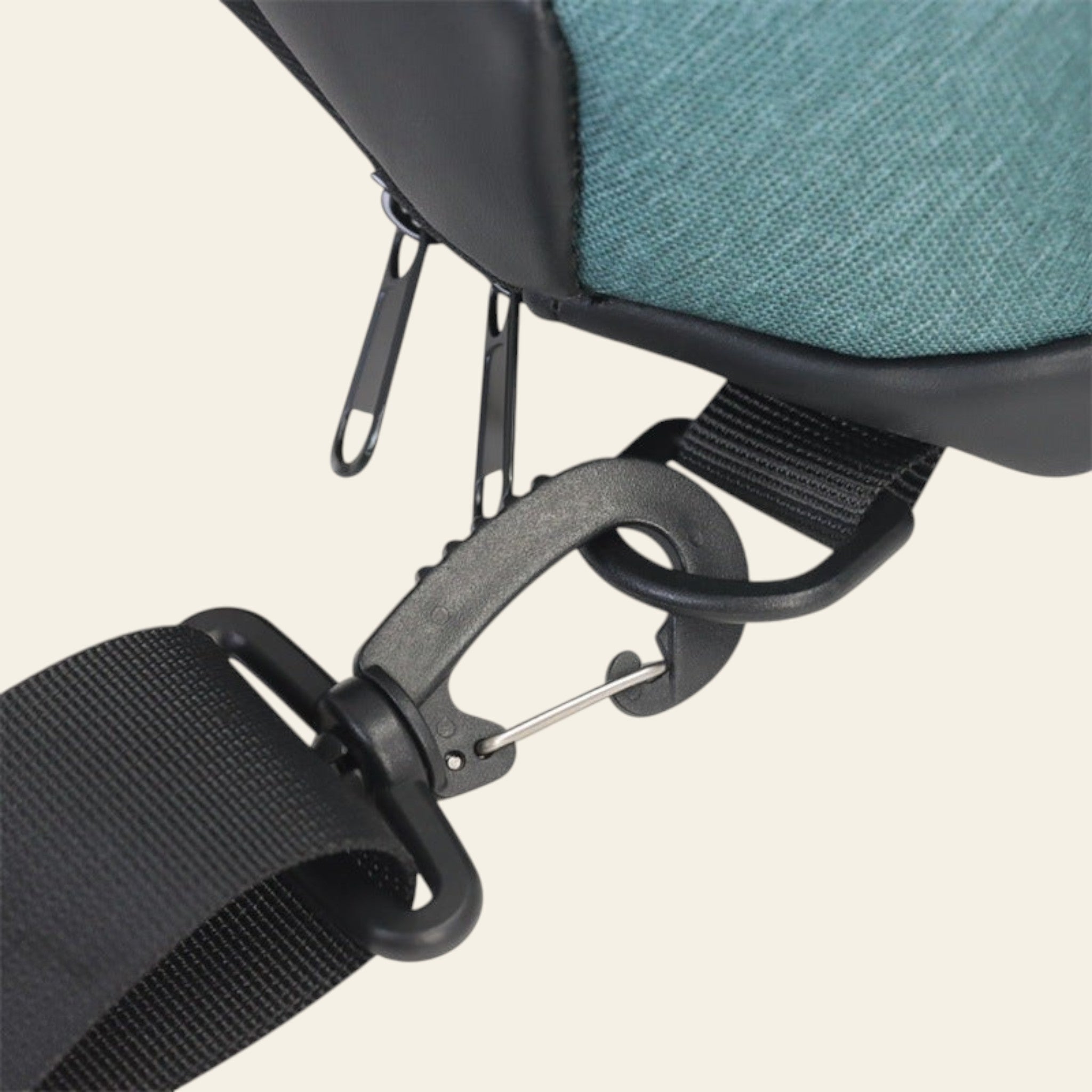 Close-up of a seat belt buckle on a vehicle seat with a teal cushion.