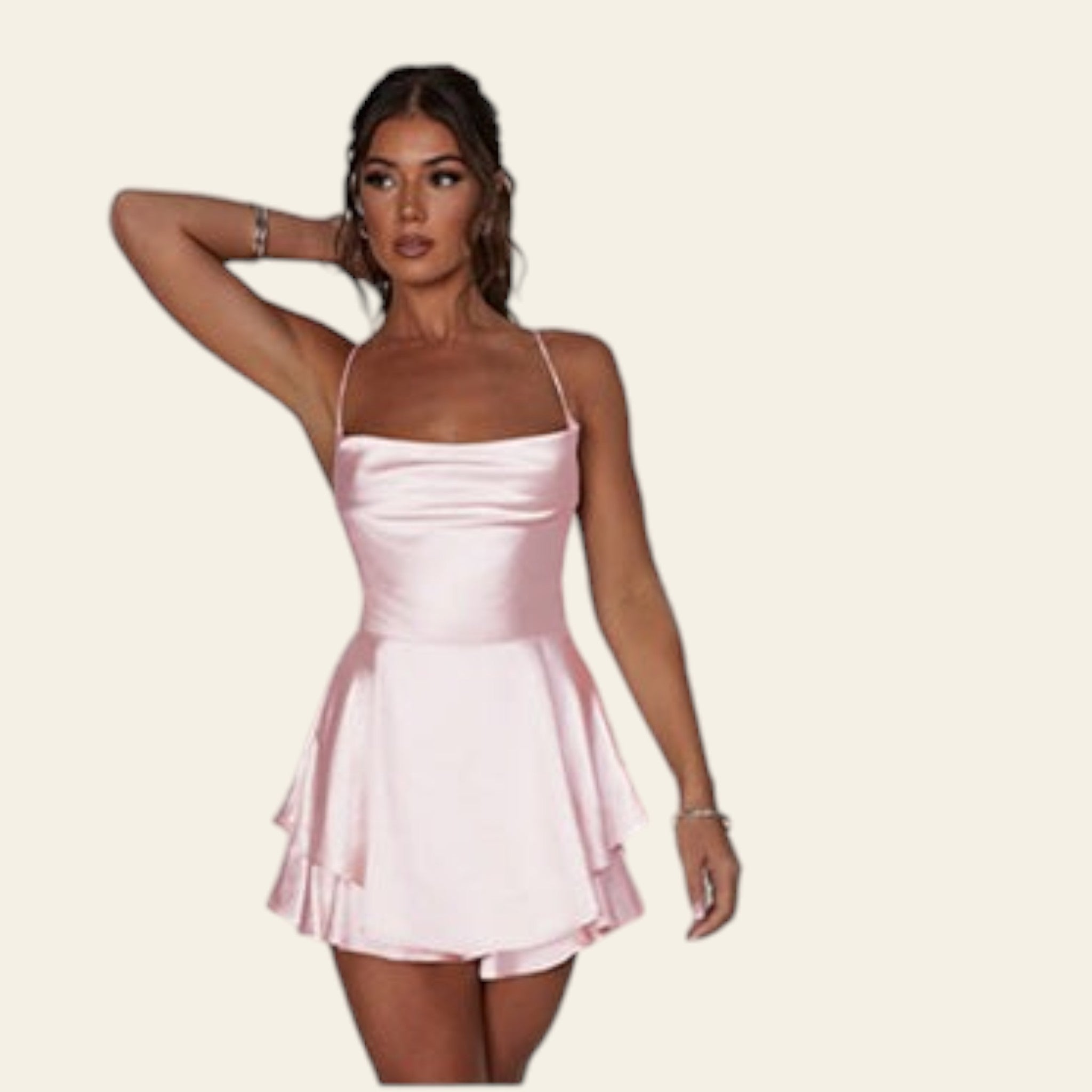 Pink satin dress on a model with a diamond bracelet on a white background