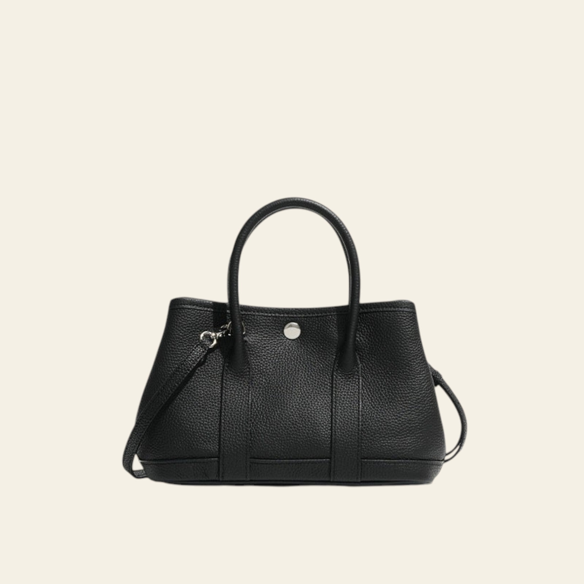 Black handbag with a strap on a white background
