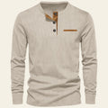 Beige long-sleeve shirt with brown buttons and placket on a white background