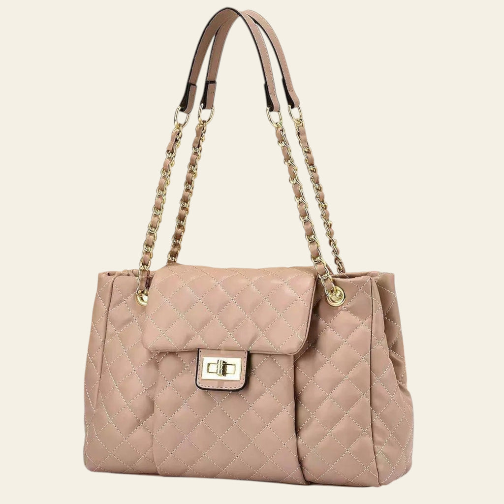 Beige quilted handbag with gold chain strap on a beige background